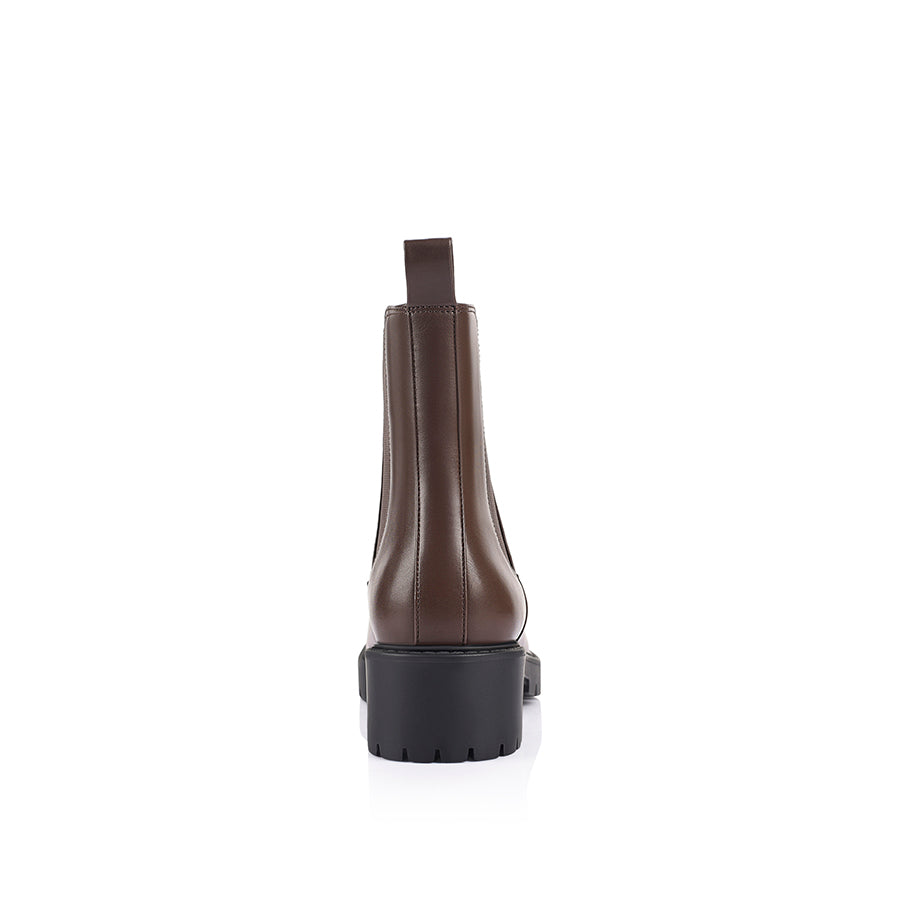 Brown Chelsea boot with a black sole with a rounded toe shape