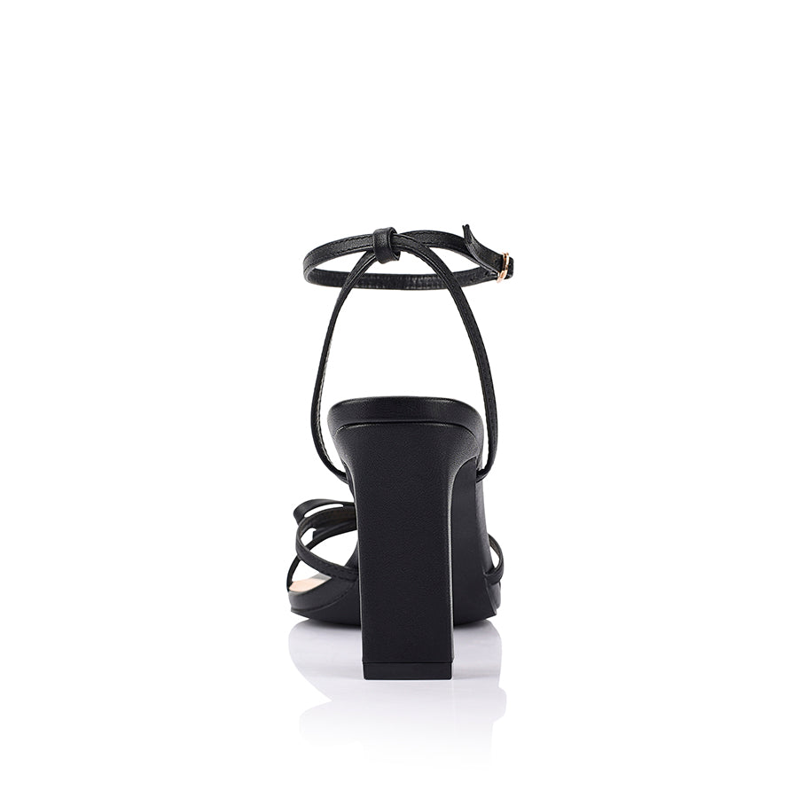Women's black vegan strappy high heels, with thin straps, bow detail and buckle up ankle strap