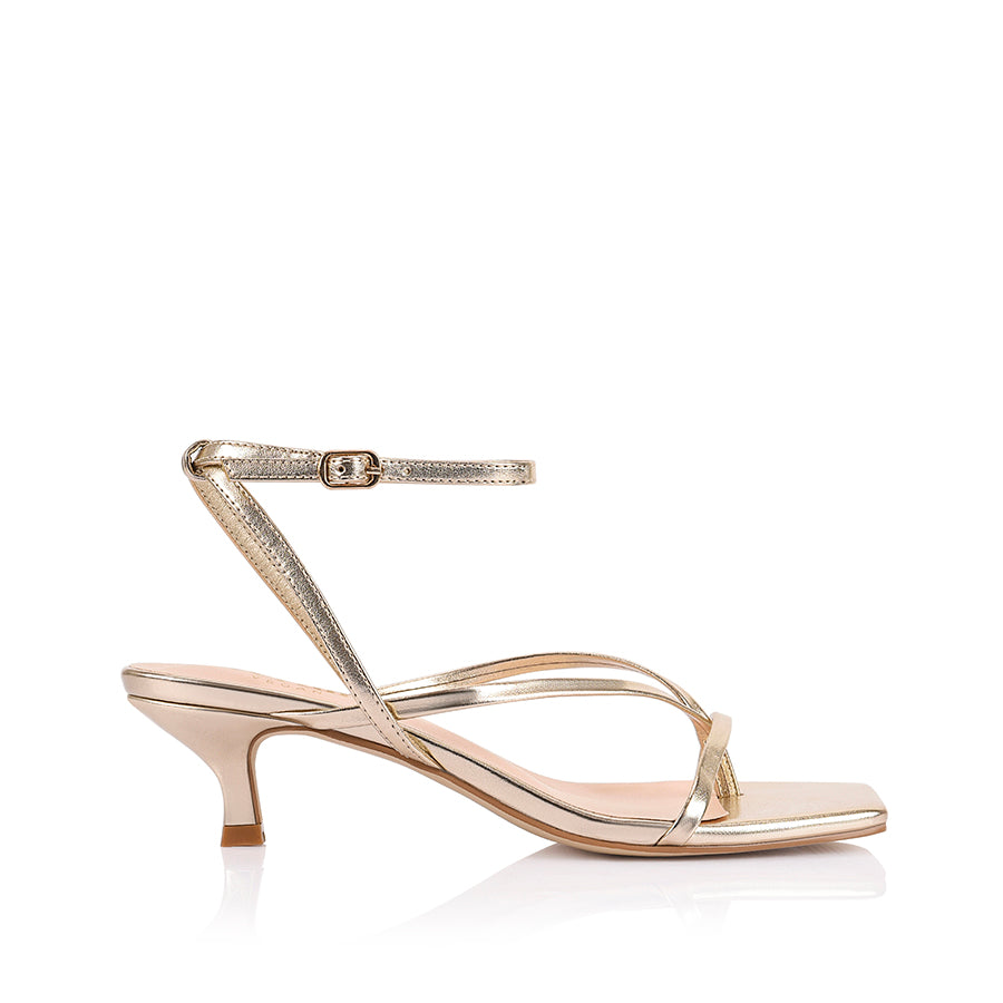 Women's low kitten heel, strappy thong style with adjustable ankle strap in metallic champagne gold