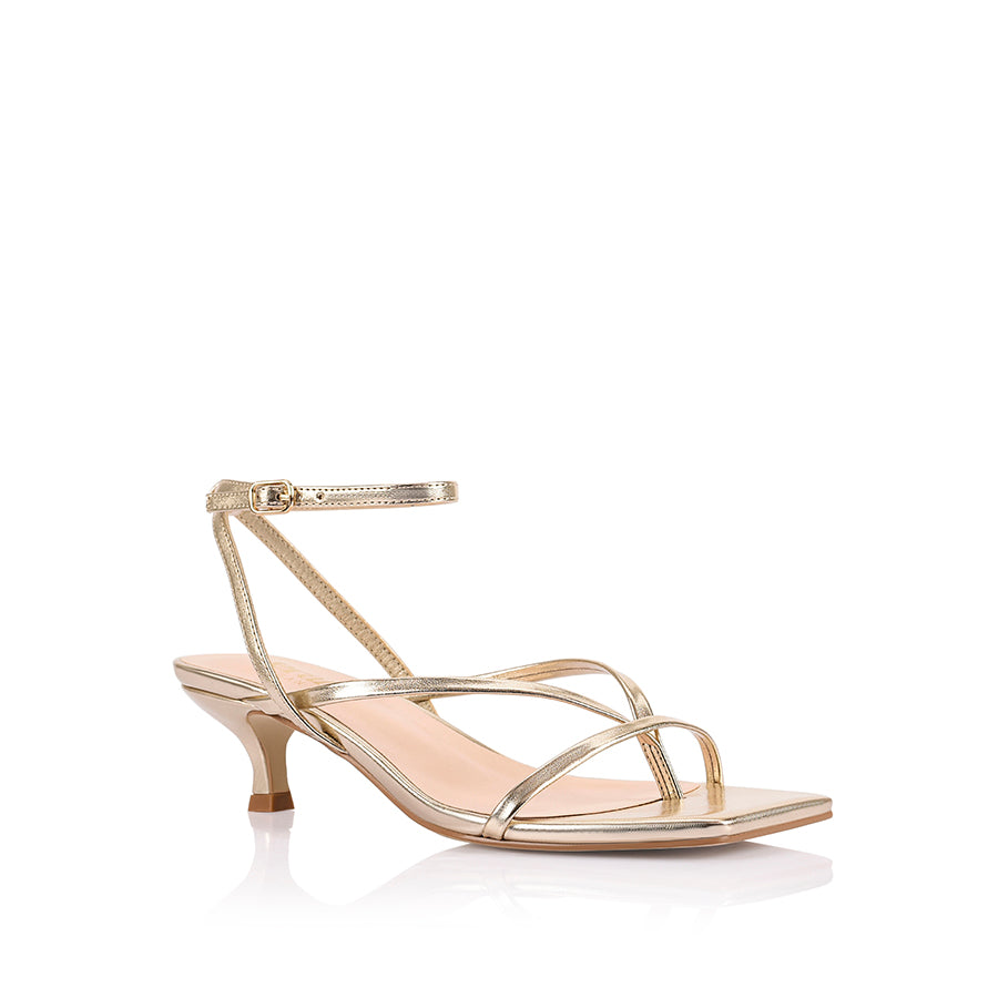 Women's low kitten heel, strappy thong style with adjustable ankle strap in metallic champagne gold