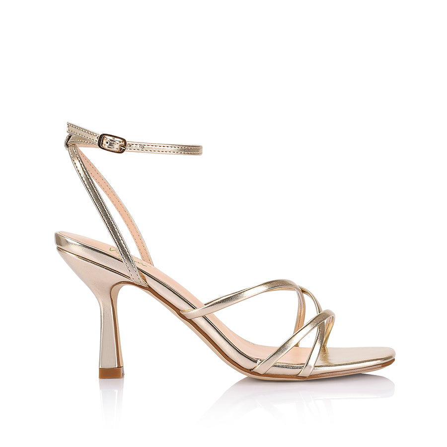 Women's heeled strappy sandal in champagne gold vegan leather with ankle strap and square toe