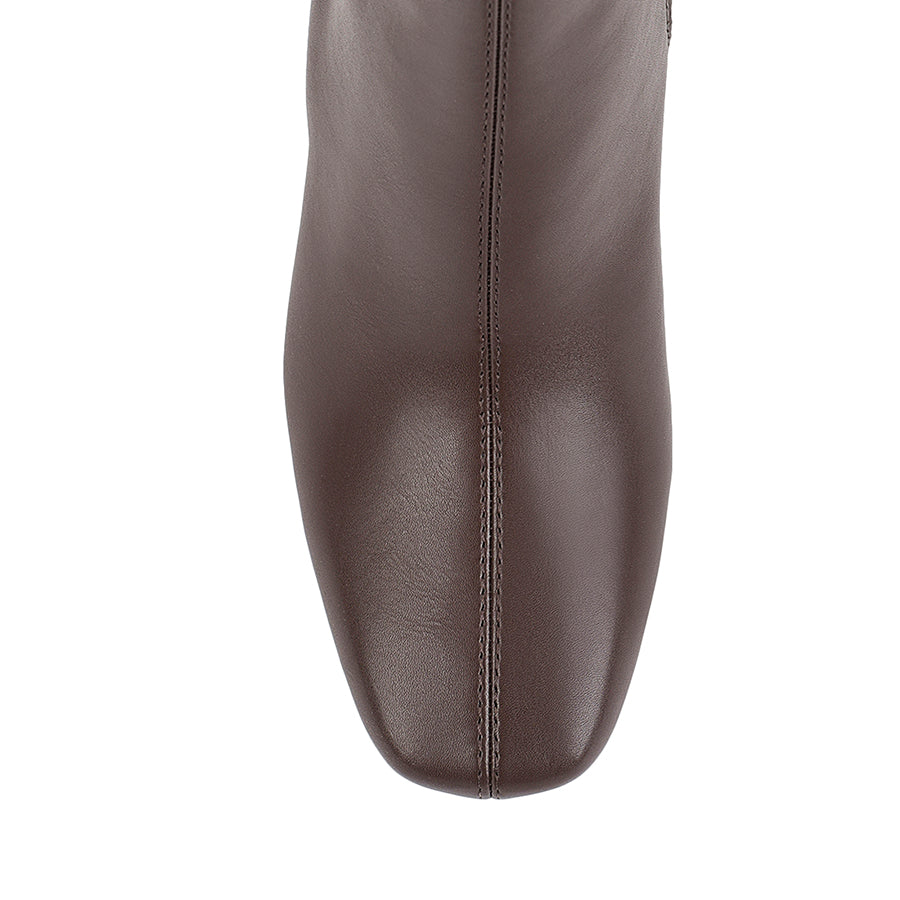 Brown knee-high boot with a mid heel and square toe shape