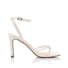 Women's chalk white vegan strappy high heels, with thin straps, bow detail and buckle up ankle strap 