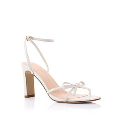 Women's chalk white vegan strappy high heels, with thin straps, bow detail and buckle up ankle strap 