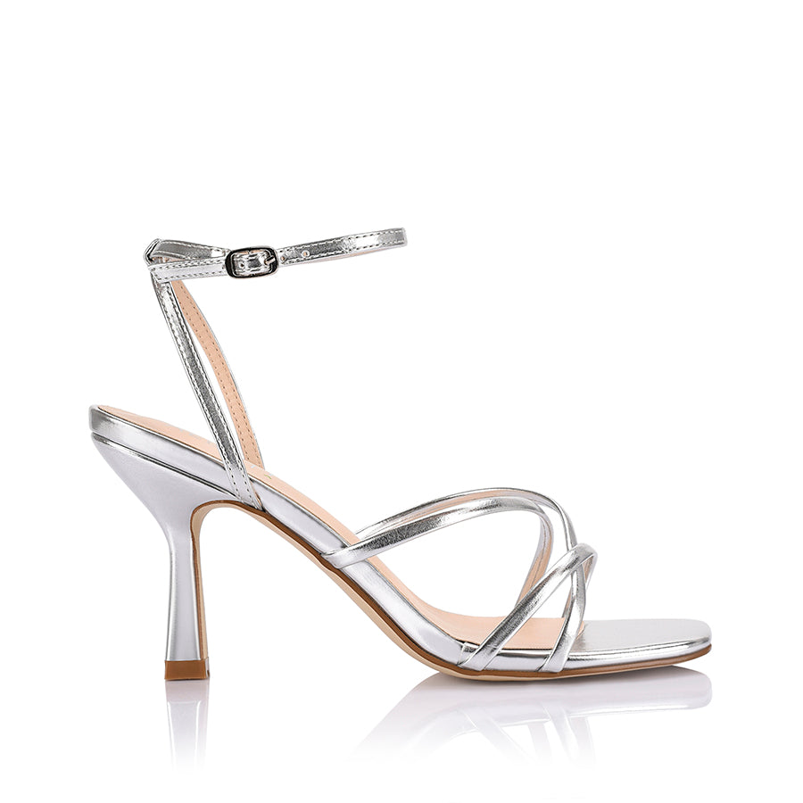 Women's heeled strappy sandal in metallic silver vegan leather with ankle strap and square toe